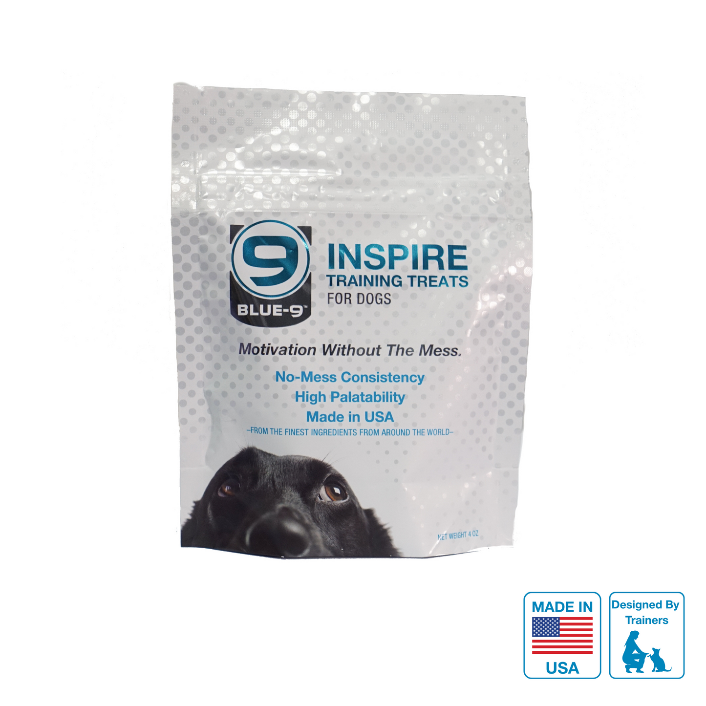 A sealed bag of INSPIRE dog training treats with a label showing the brand logo, product name, and an image of a dog. The bag is marked as made in USA and designed by trainers.