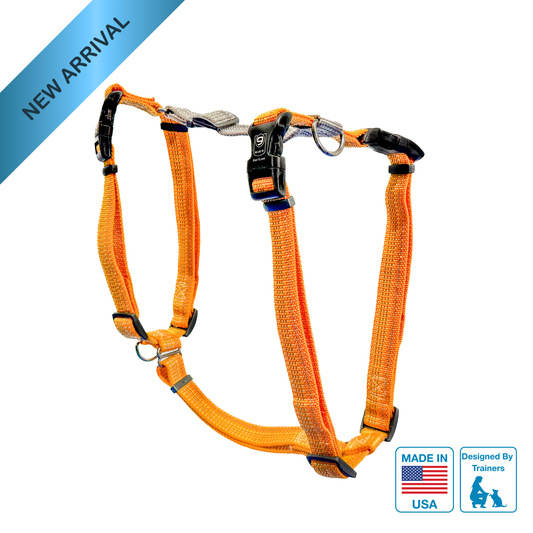 Orange dog harness with metal d-ring on a white background, featuring 'Made in USA' and 'Designed by Trainers' logos.