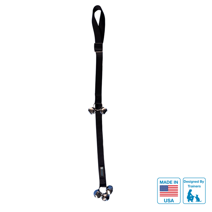 A black dog training bell with metal hardware, designed to hang on a door knob, with a label indicating it is made in the USA and was designed by Blue 9 Pet Products.